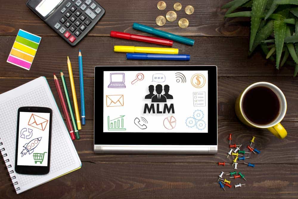 Tablet on a table with the letters "MLM" on it