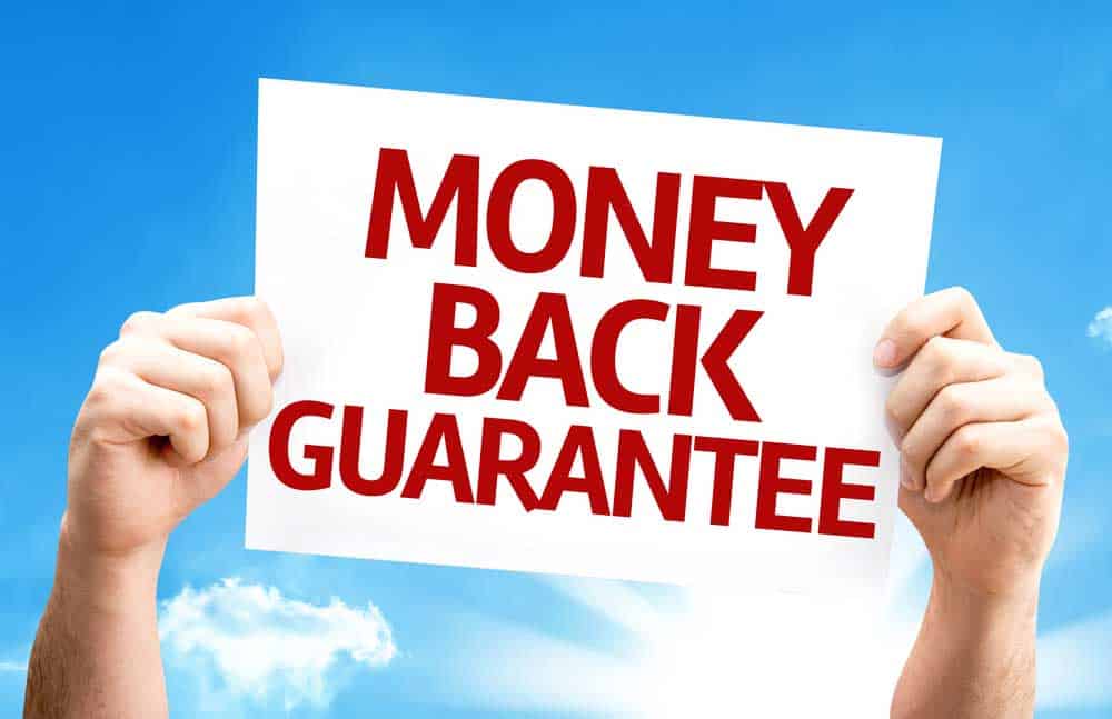 Hands holding a sign with the text "Money back guarantee"