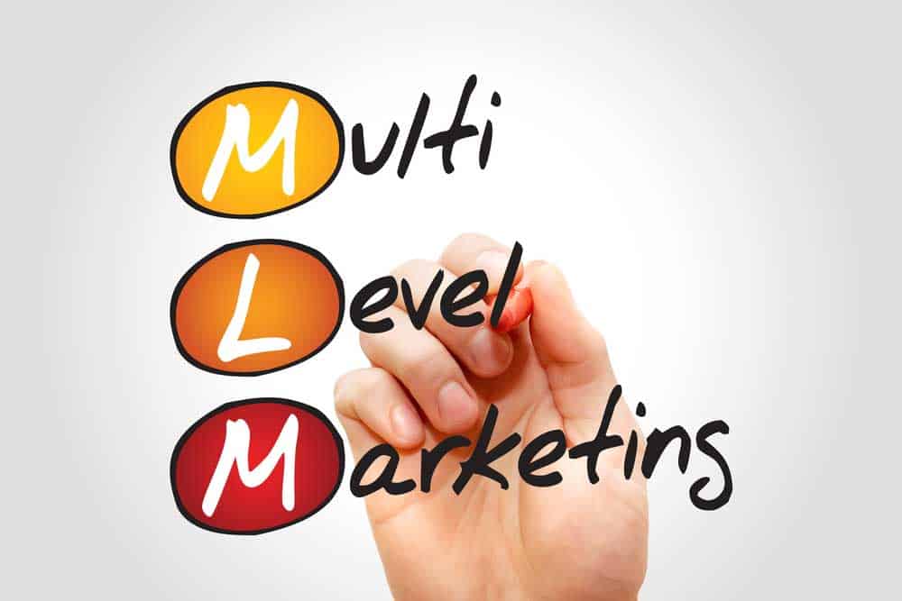 Hand writing the words "Multi Level Marketing"