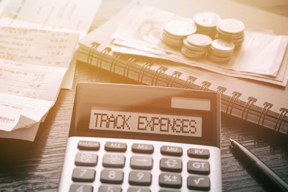Track you income and expenses. Calculator with the words "Track Expenses".