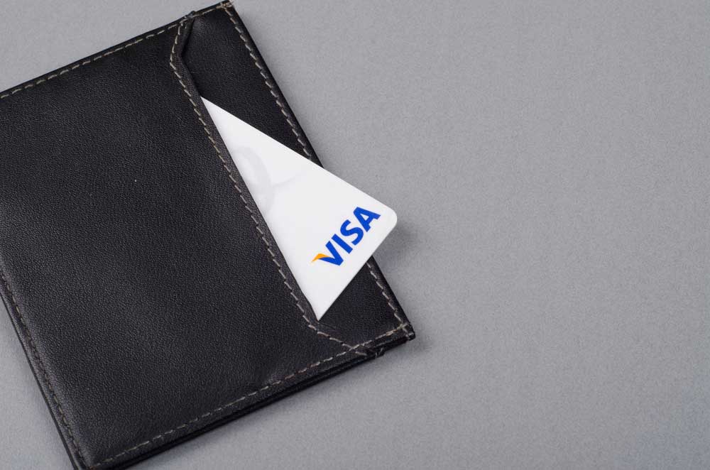 Visa credit card in a black wallet