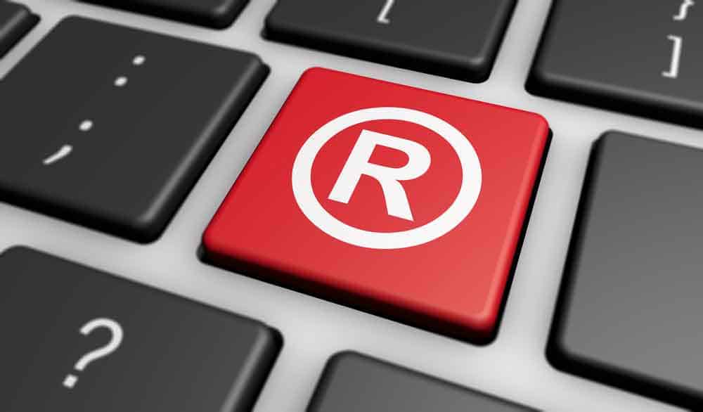 Keyboard with one red key and the letter "R" for "Registered Trademark"