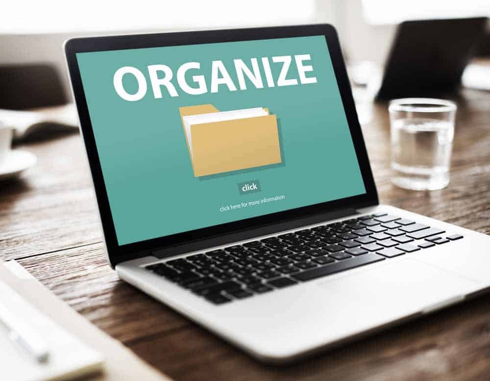 Laptop with a yellow folder and the word "Organize" on the screen.