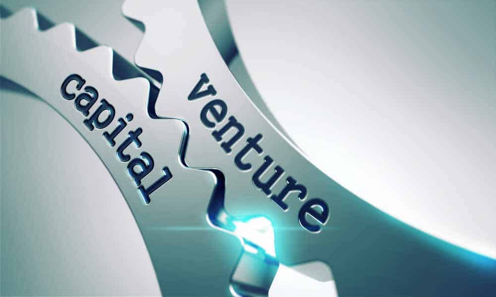 The words "Venture capital" written on metal gears