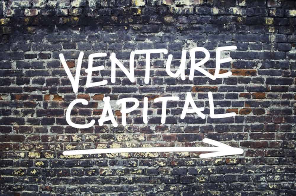 "Venture capital" text on a brick wall.