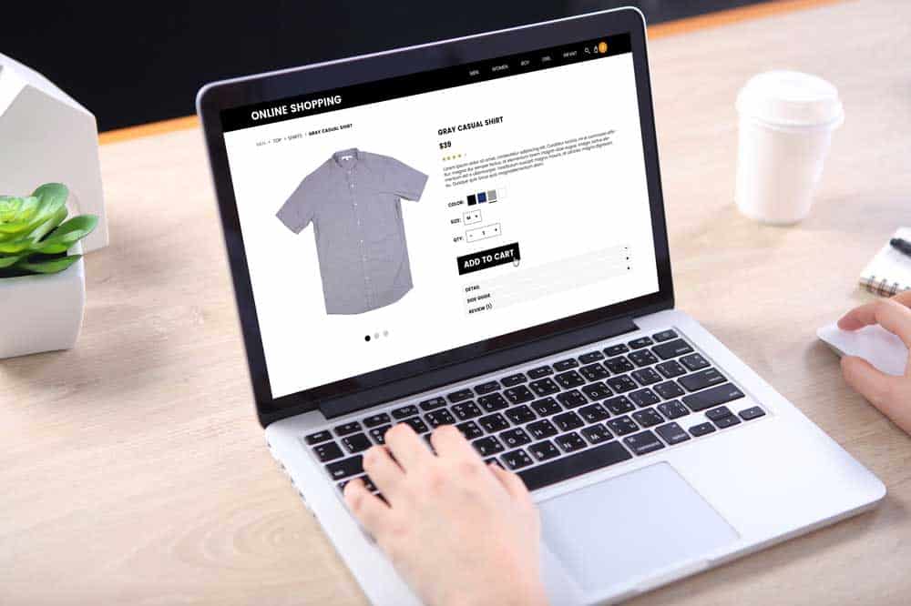 Laptop showing an ecommerce website selling shirts.